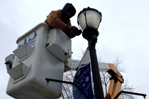 j & j electrical workers working on light post